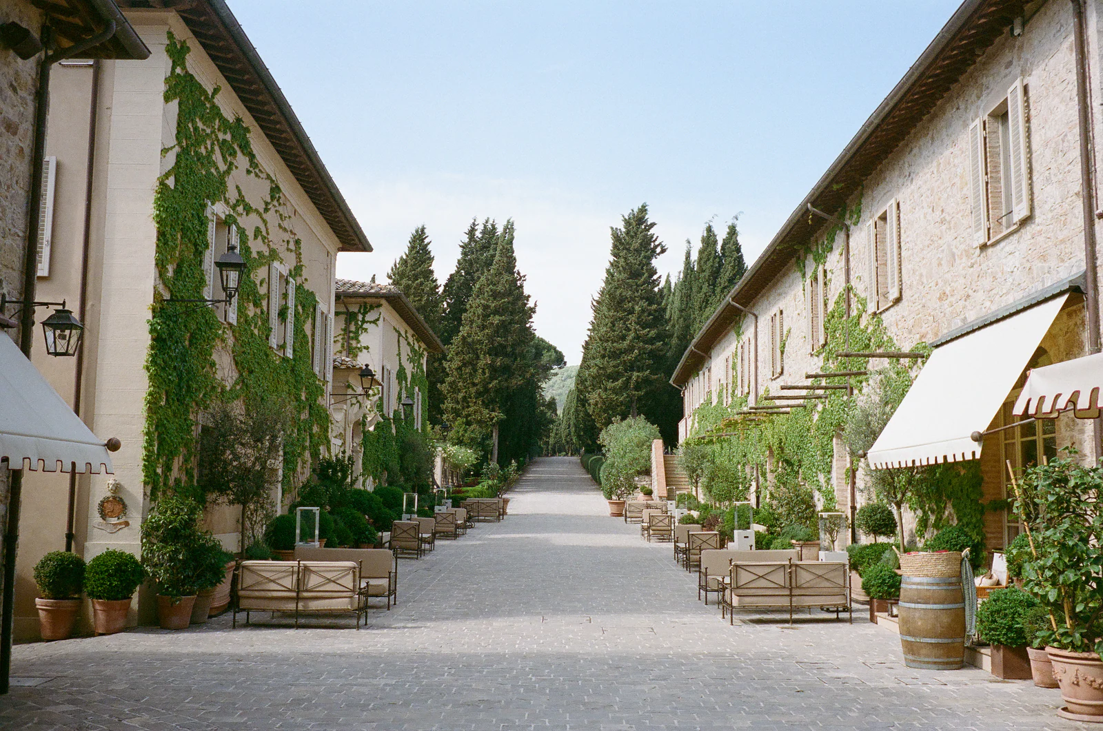 Stone lane of the thousand-year borgo of Castiglion del Bosco, A Rosewood Hotel, with potted lemon trees, Tuscany