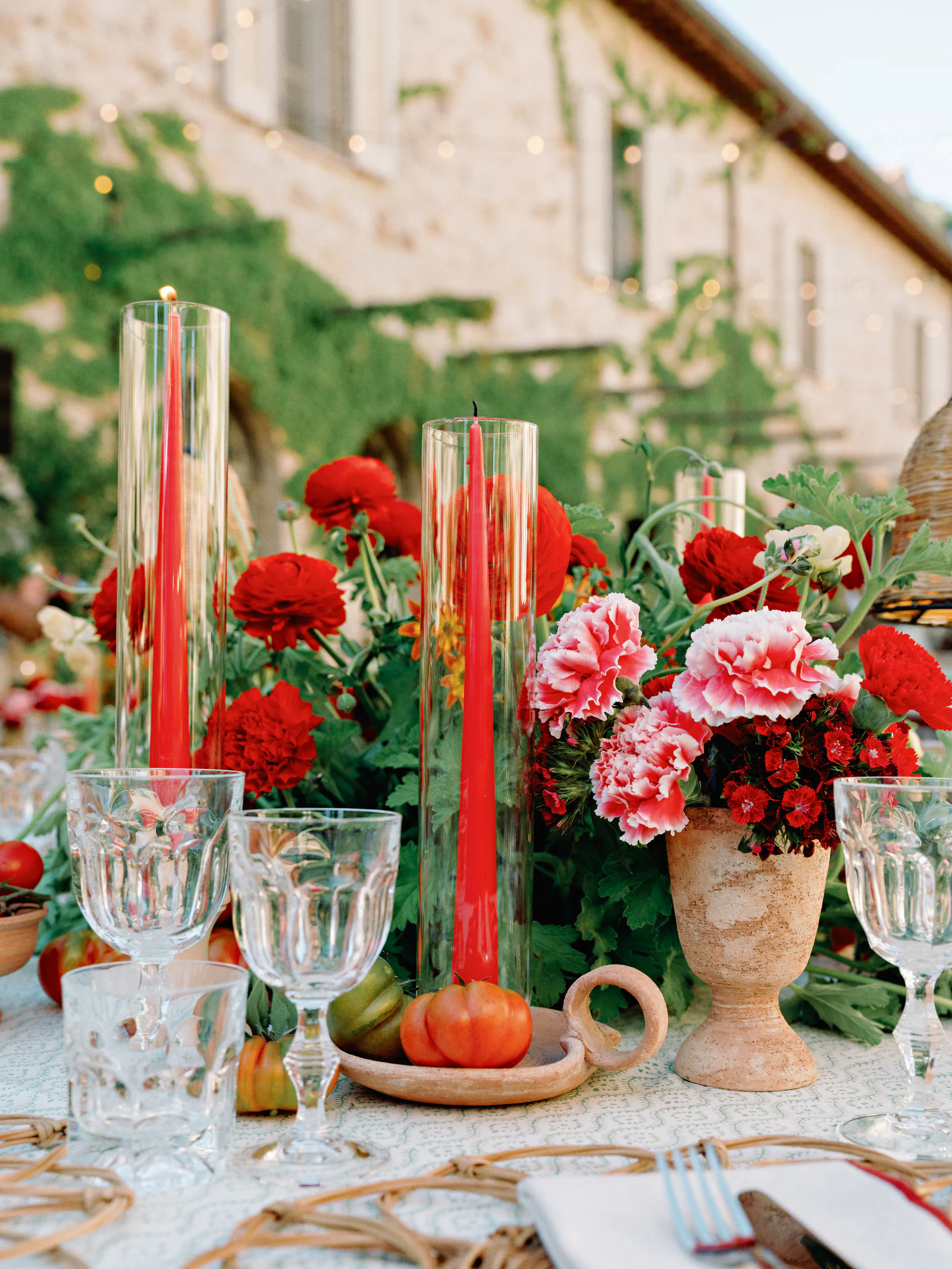 Red carnations, tapers and cut glass on the welcome-dinner table in the borgo, Castiglion del Bosco, A Rosewood Hotel