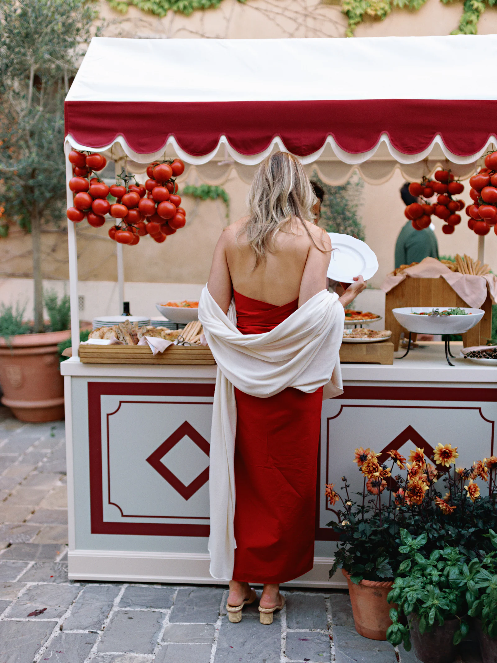 Striped kiosk hung with tomatoes at the welcome party in the borgo of Castiglion del Bosco, A Rosewood Hotel, Tuscany