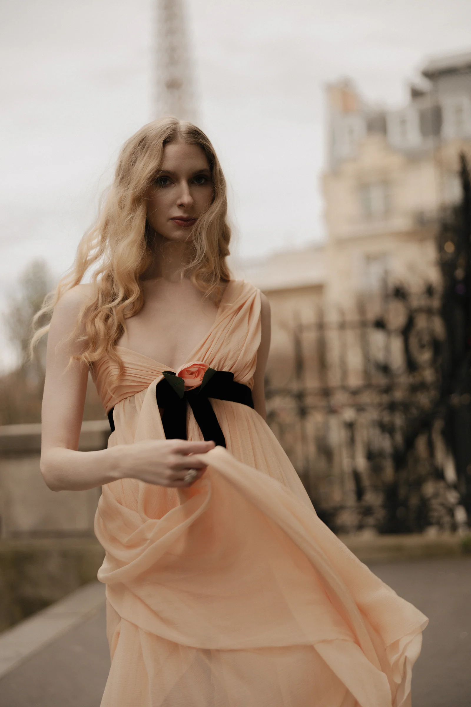 The bride in the pink vintage Chanel gown, a black velvet bow at the waist, in the Tuileries, Paris