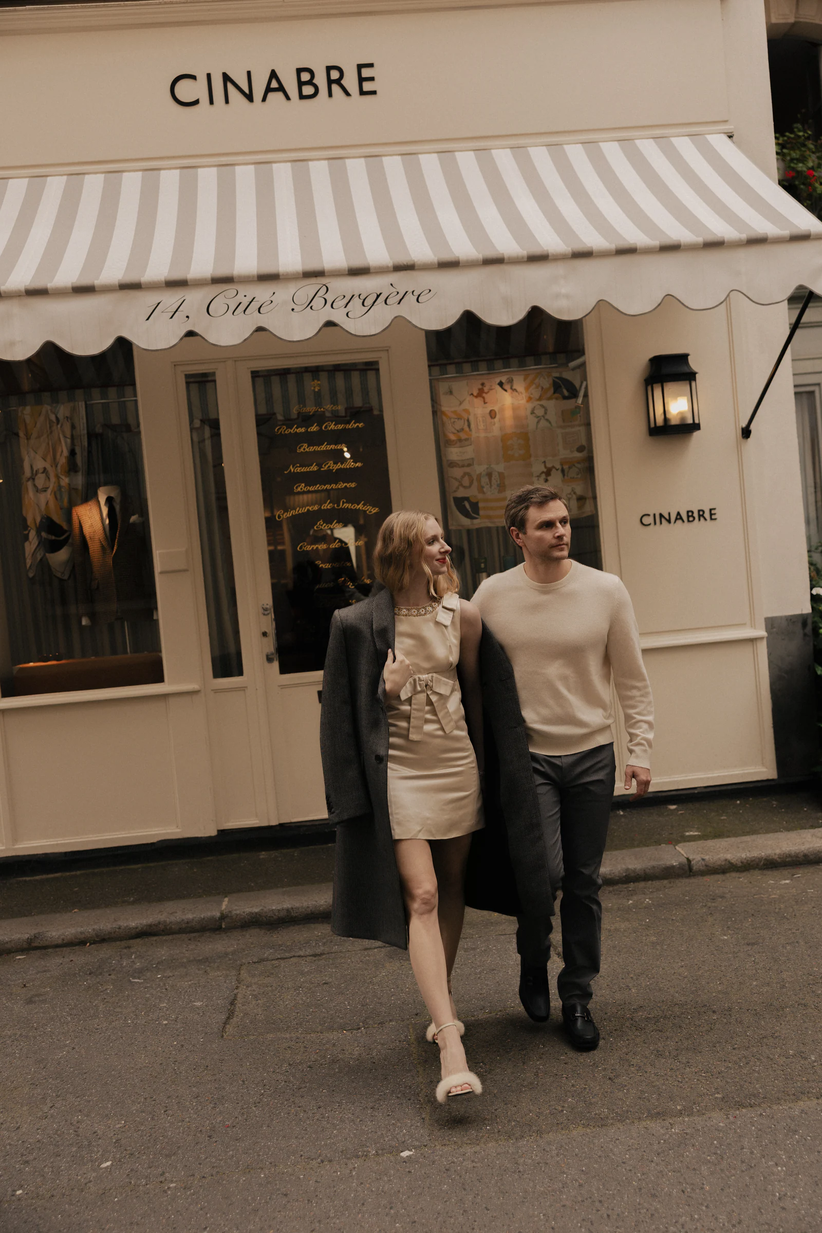 Couple outside the Cinabre shopfront in Paris