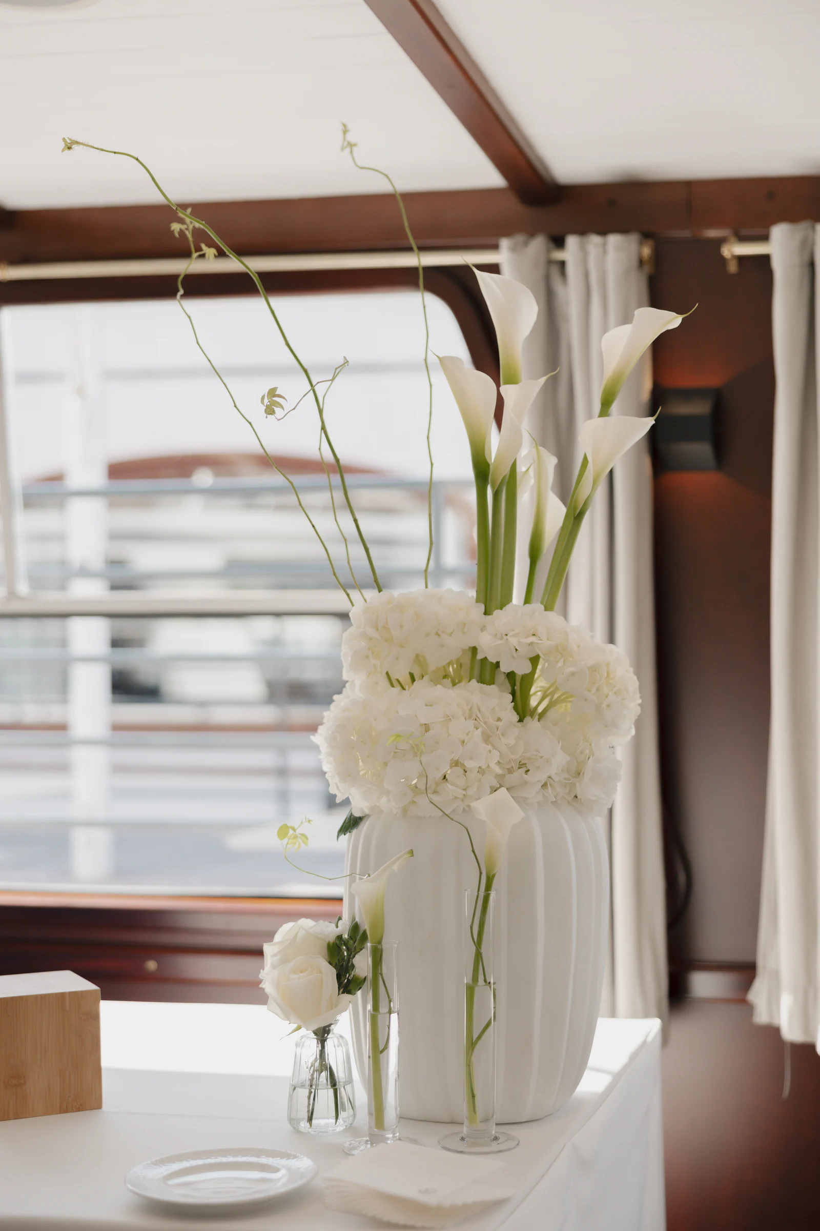 White calla lilies on the table of a private Seine boat, Paris